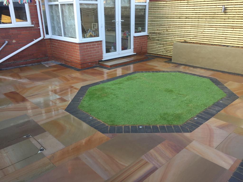 Paved patio and lawn feature created by MTS Landscaping
